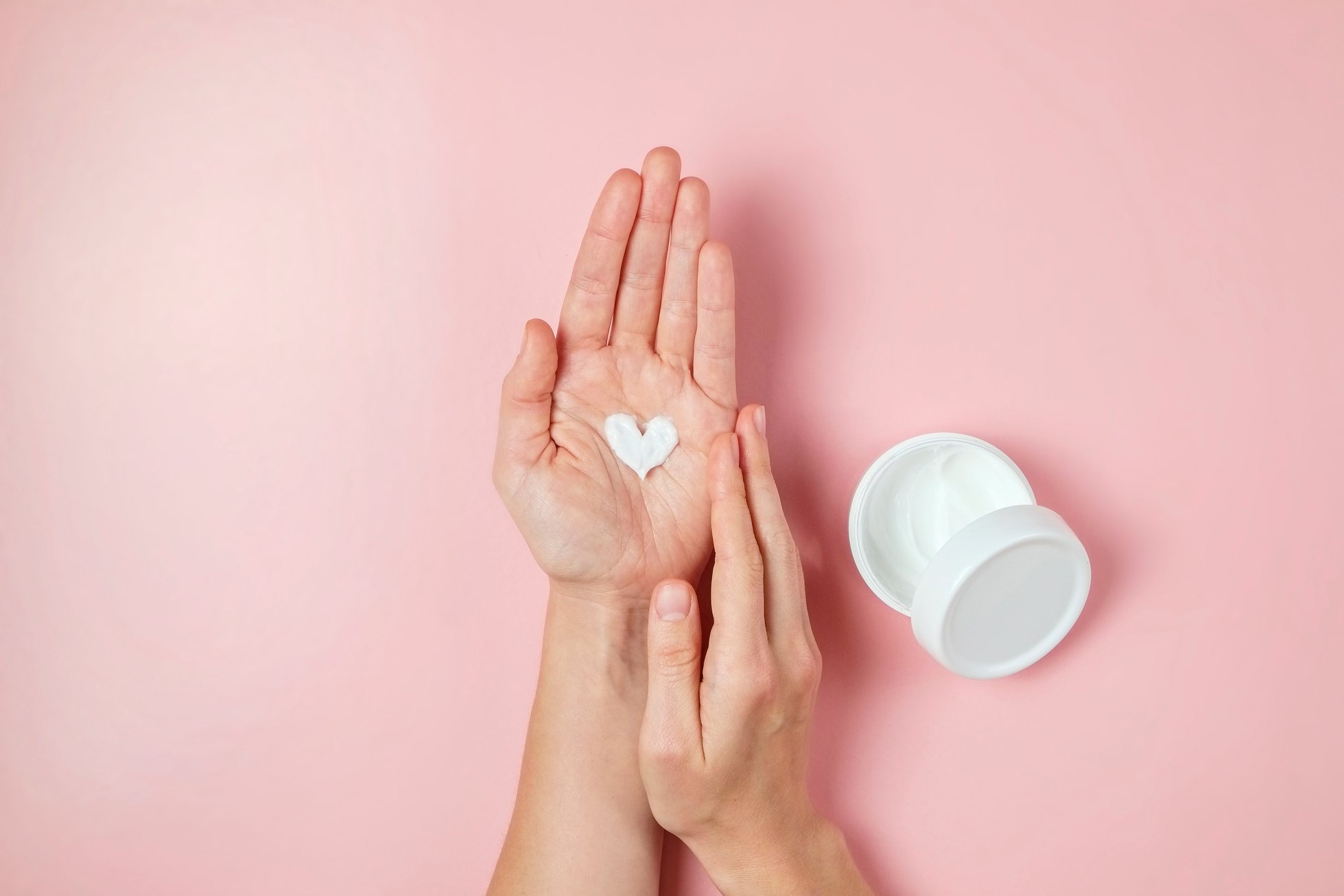 Female's hands applying skincare product